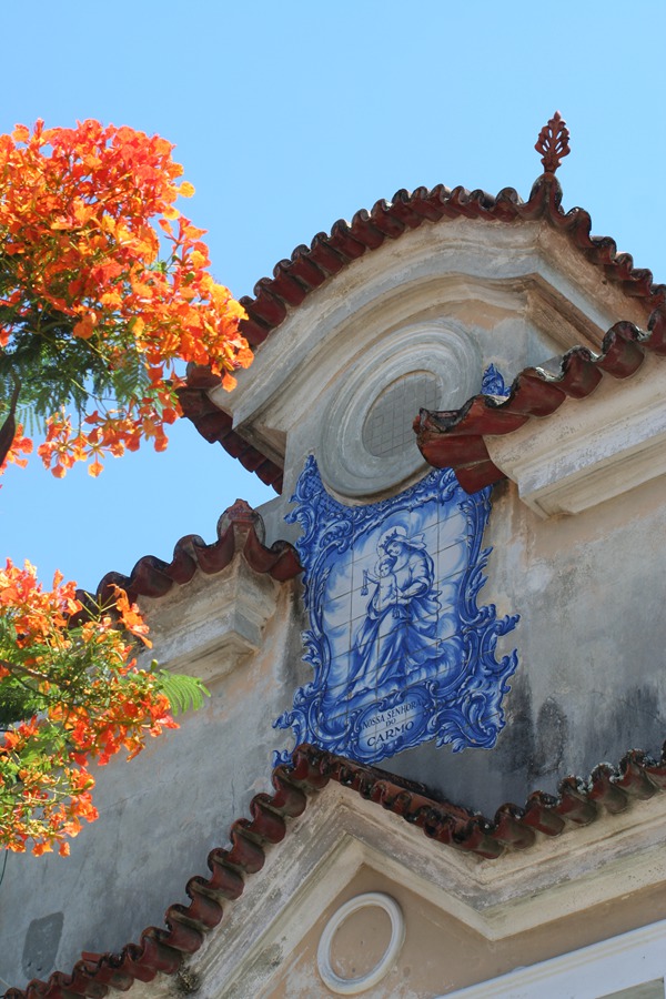 Colorful contrast between Beautiful Portuguese Colonial Architecture and summer flowers