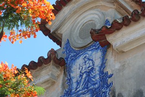 Colorful contrast between Beautiful Portuguese Colonial Architecture and summer flowers